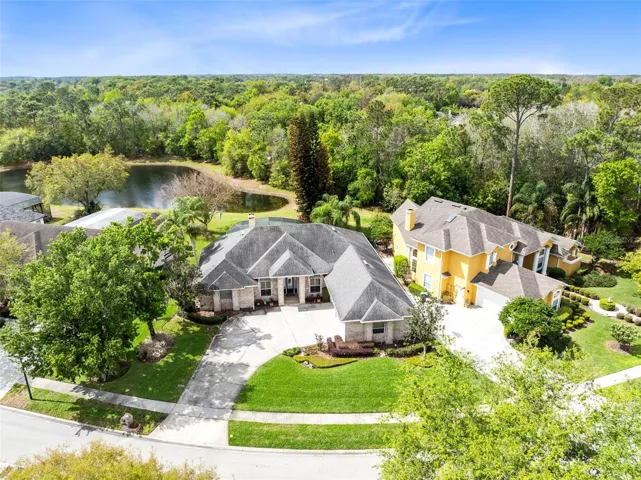 AERIAL VIEW OF HOME WITH POND BEHIND