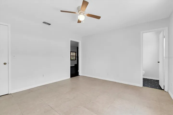 View of closet and into bathroom