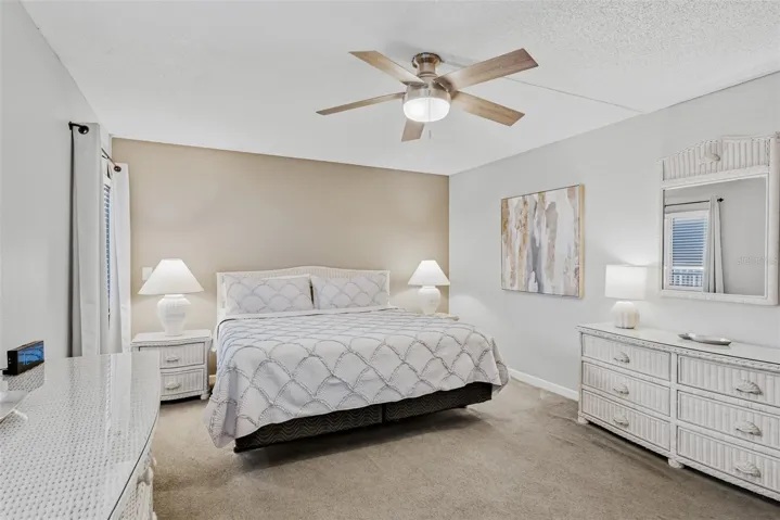 Spacious primary bedroom with a king bed