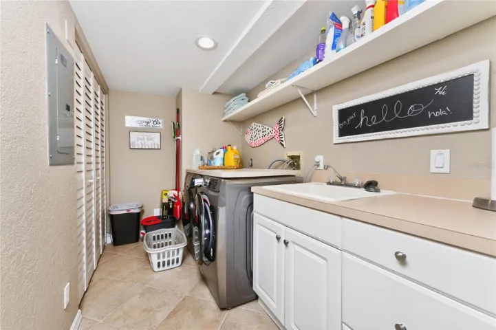 LARGE LAUNDRY ROOM WITH DEEP SINK. CLOSETS HOLDS THE AIR HANDLER AND HOT WATER HEATER.