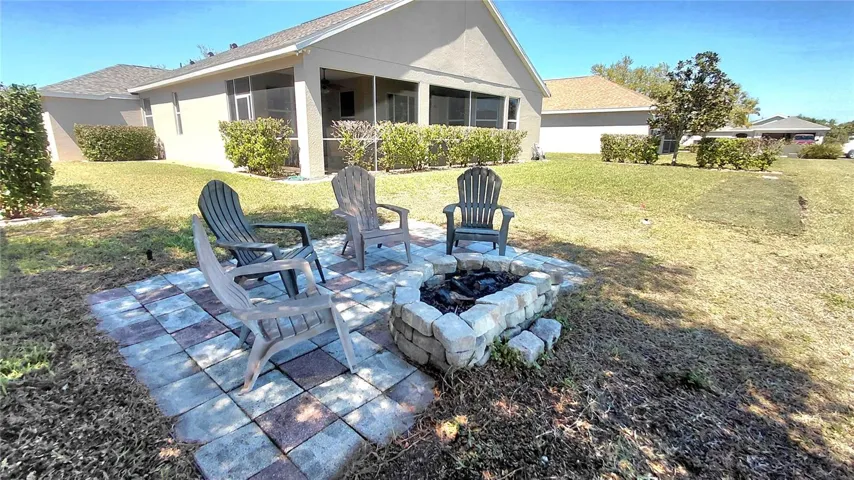Backyard fire pit and back of home