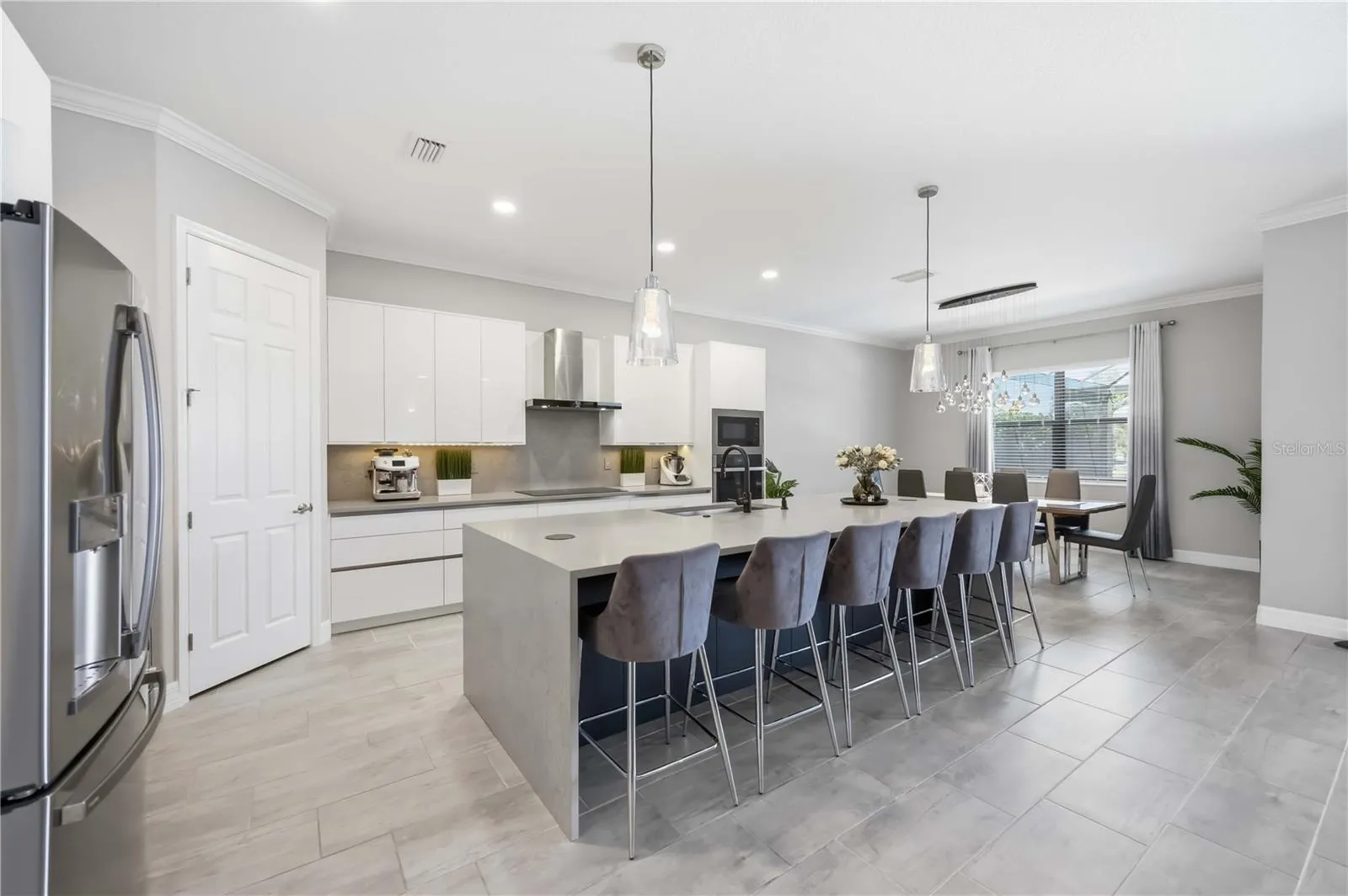 Kitchen Island has a waterfall quartz island, with upgraded plumbing in the island