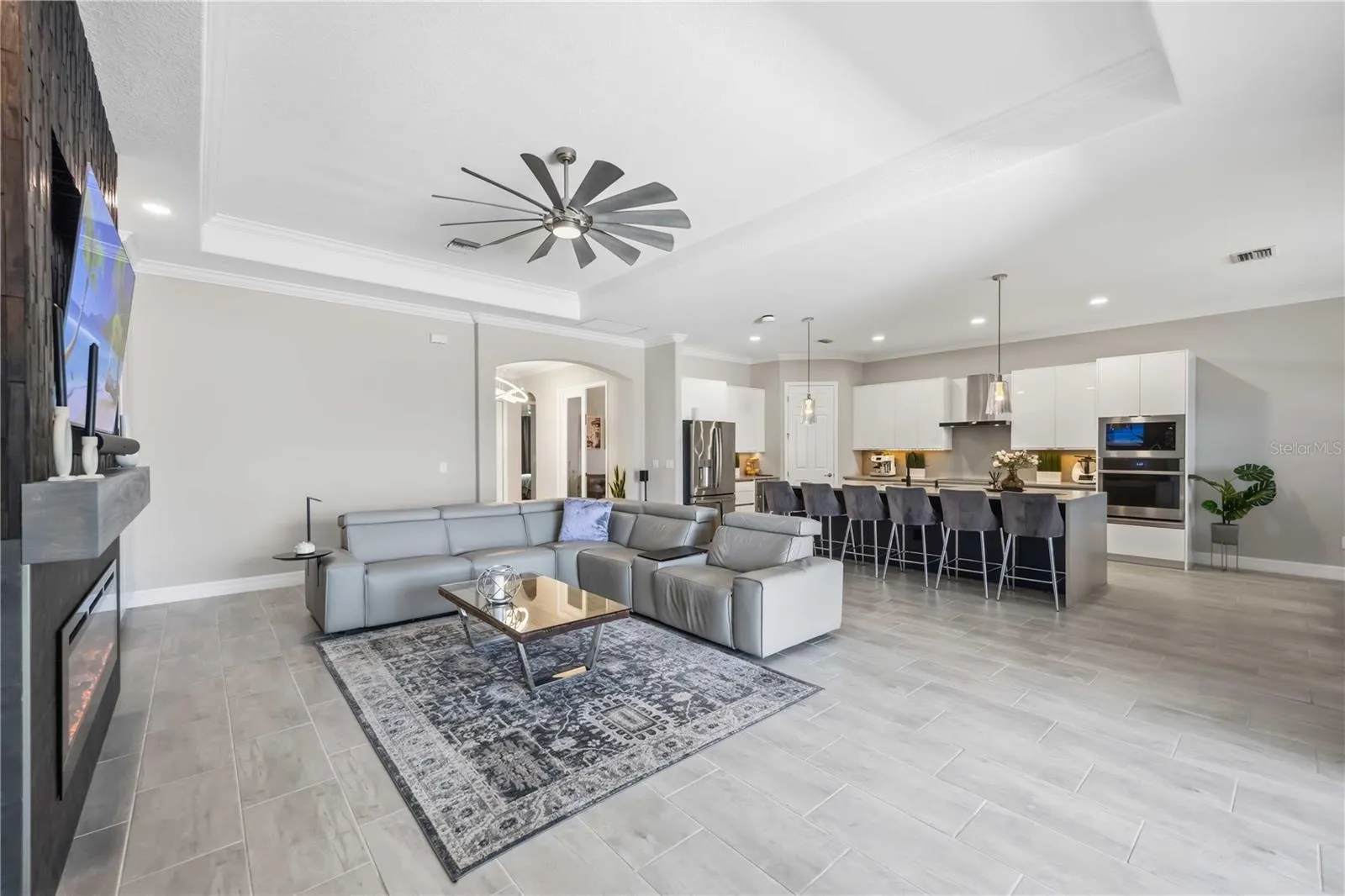 Living room has built in cabinets for extra storage and stunning electric fireplace for ambiance