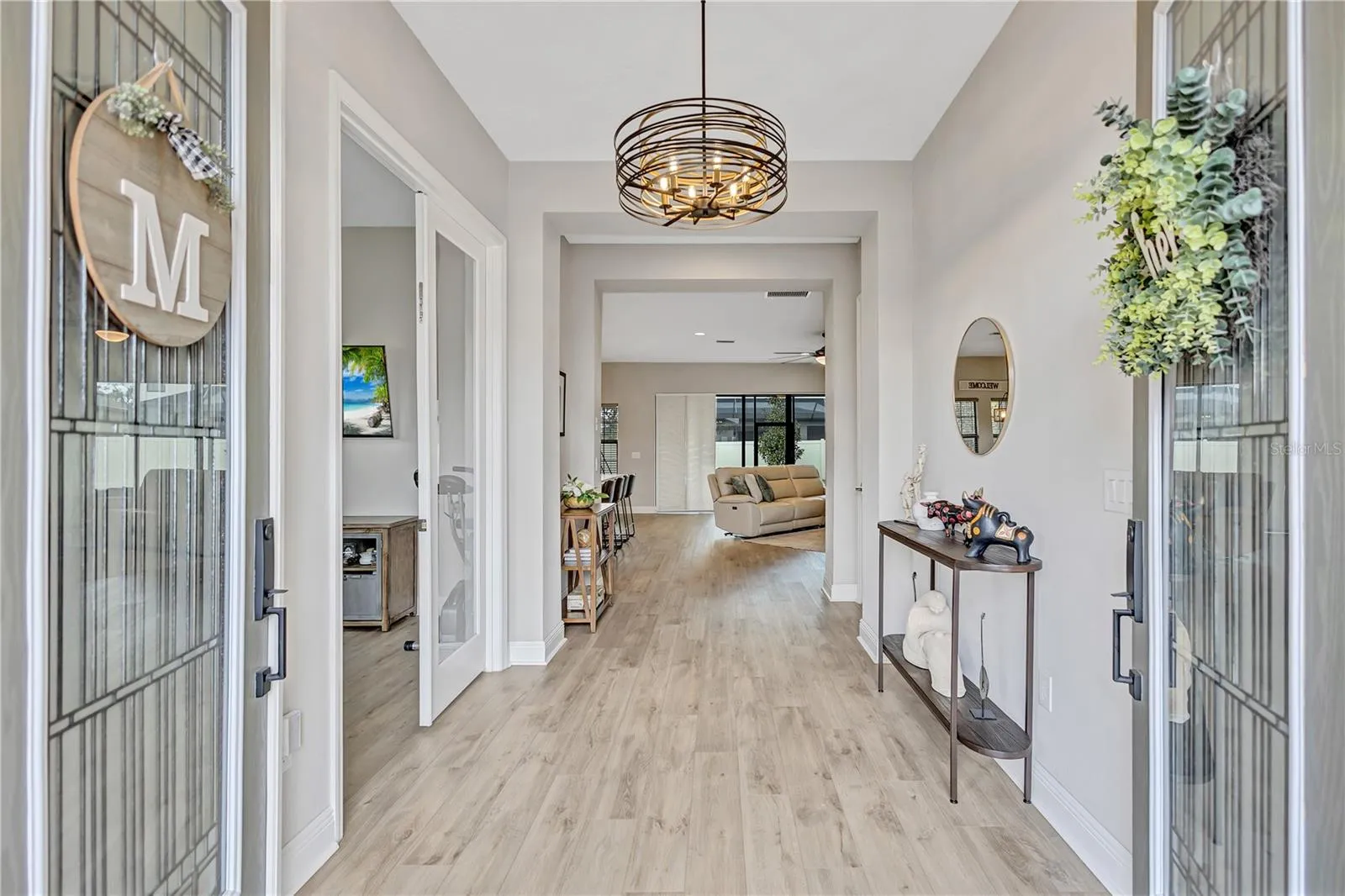 Double door entry opens to a light-filled space where designer details immediately set the tone.