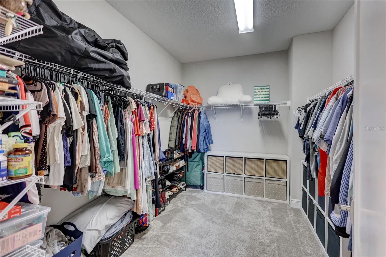 Expansive walk-in closet offering generous space for wardrobe &amp; storage!