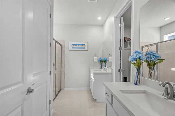 Primary bathroom featuring dual sinks and a well-designed layout.