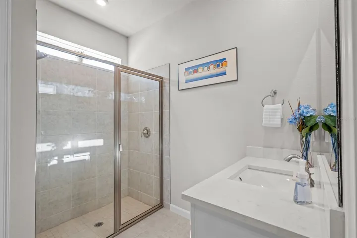 Primary bathroom featuring dual sinks and a well-designed layout.