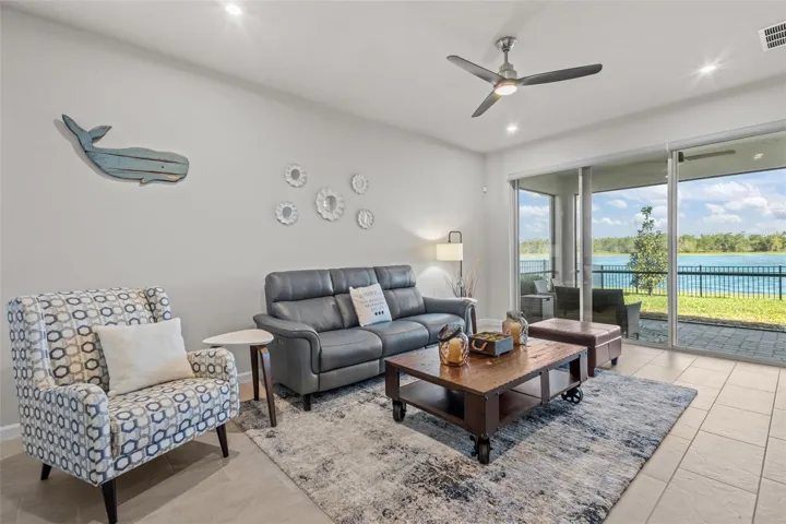 Open living room with large sliding glass doors overlooking the water.
