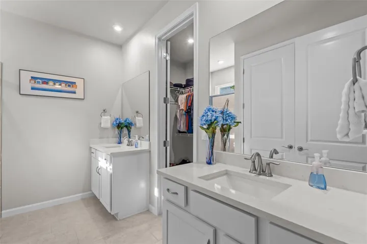 Primary bathroom featuring dual sinks and a well-designed layout.