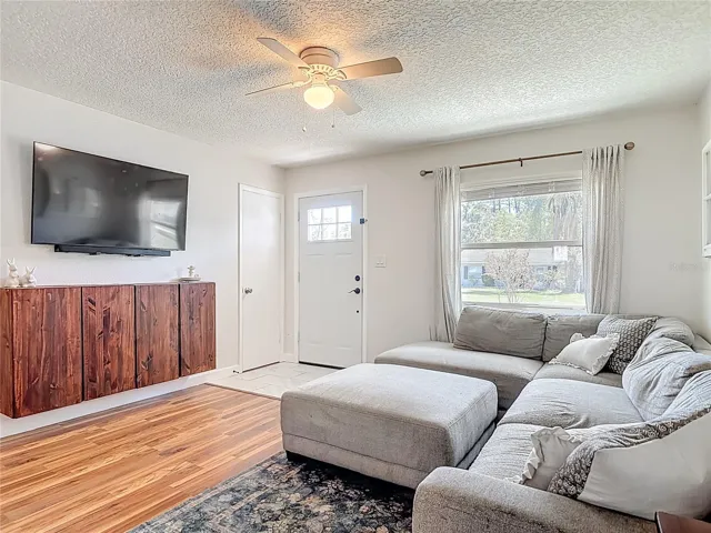 living room off entryway with hall coat closet