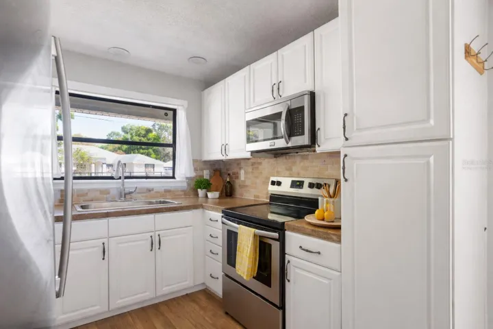 Kitchen with solid countertops - virtually staged