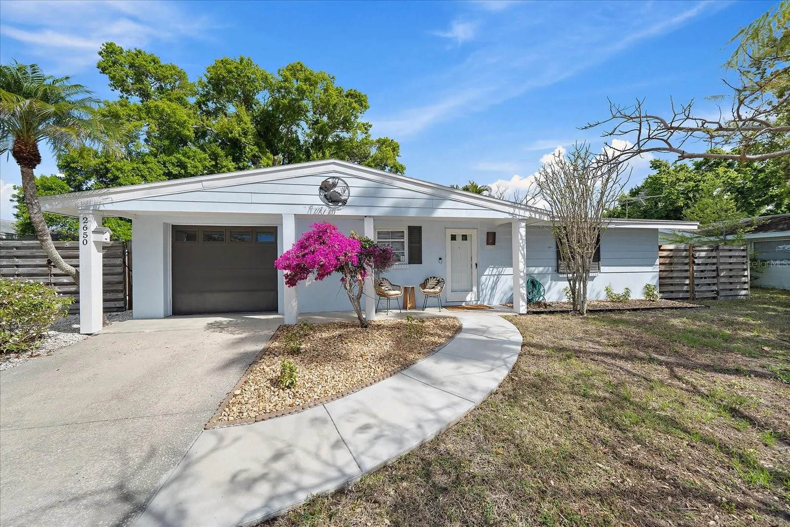 Quintessential South Gate ranch home. Cozy front porch seating and fully fenced in backyard