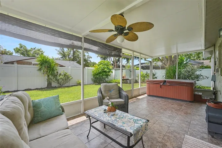 Screen enclosed porch with a hot tub