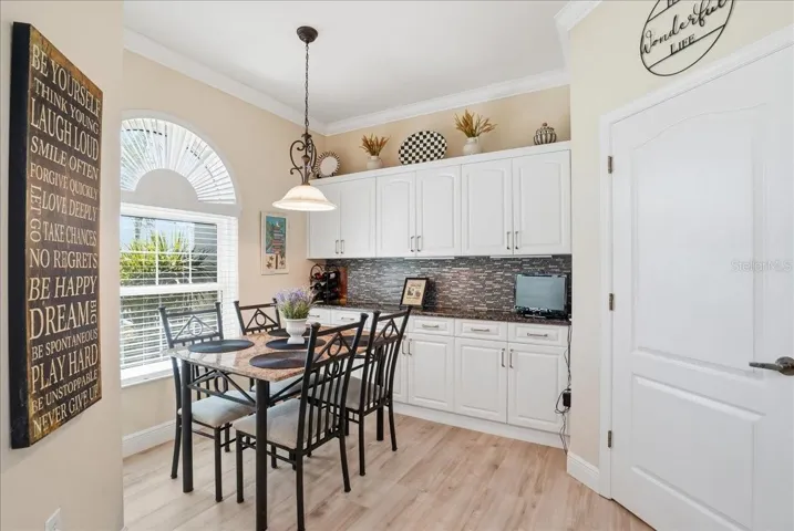 kitchen table area with extra storage cabinets
