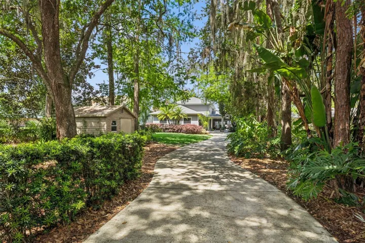 Long driveway, shed for outdoor storage.