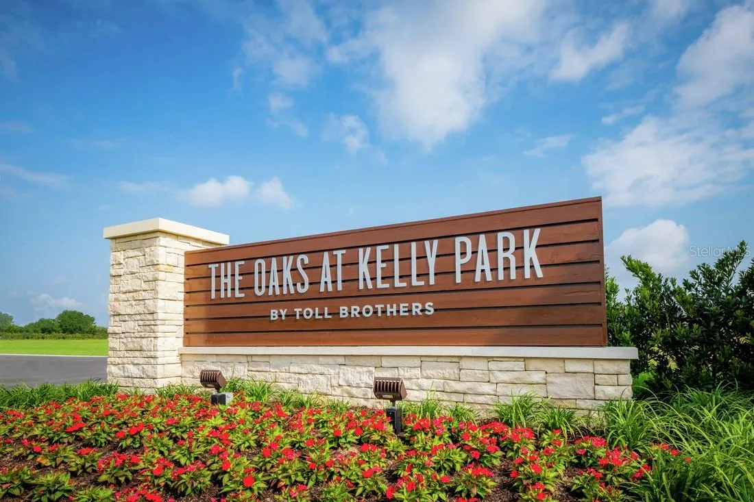 Community entrance featuring lush landscaping and a statement entrance monument