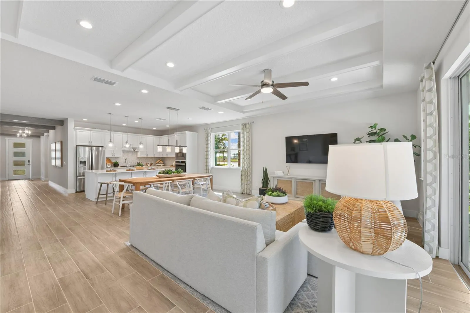 Tray ceilings highlight the great room with designer beams providing texture and flow