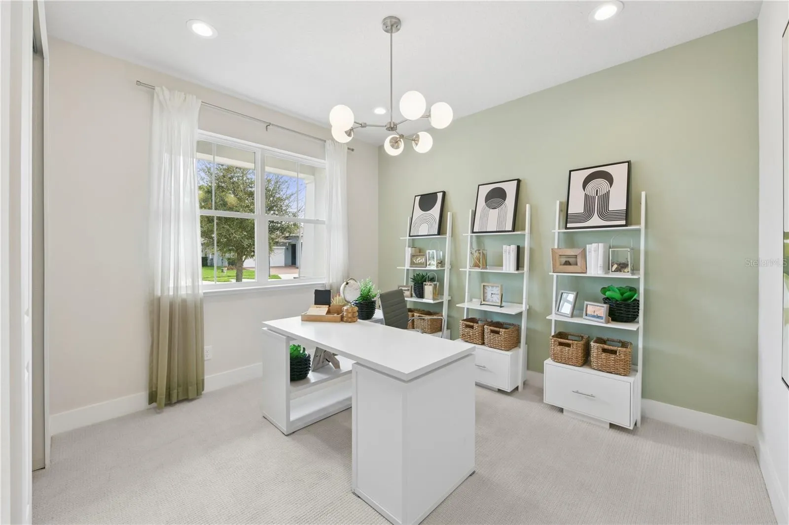 Second bedroom (staged as an office space) with a built-in closet and ample natural light