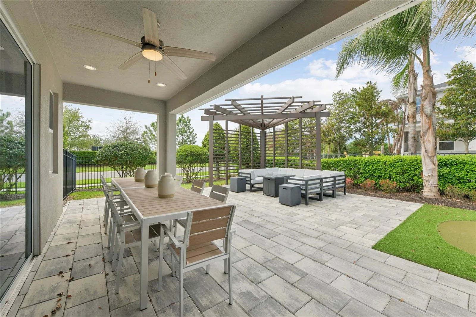 Relaxed outdoor living with an upgraded lanai, lush putting green, and stylish furnished gazebo.
