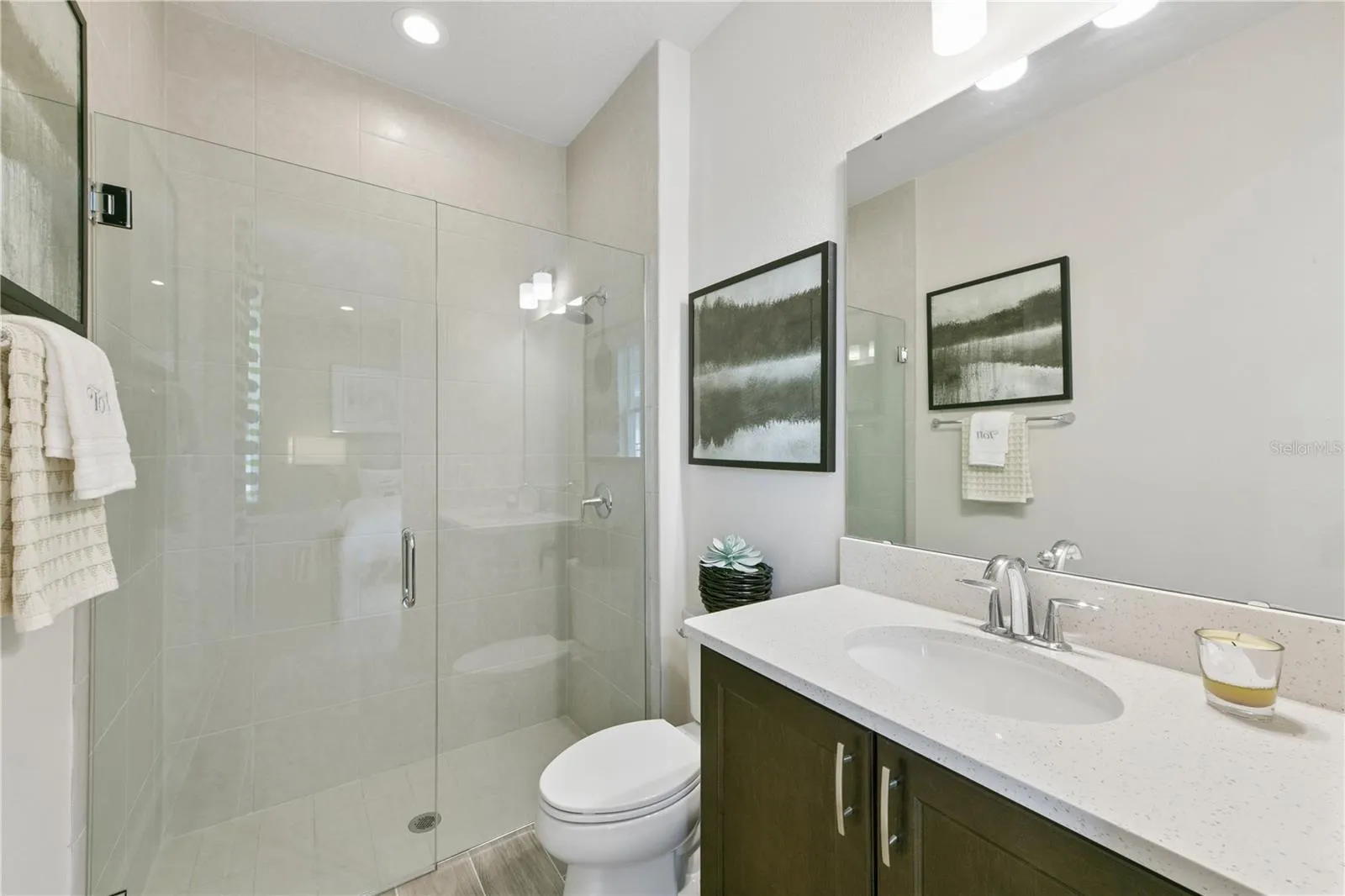 Private ensuite retreat with a spacious walk-in closet and a sleek walk-in shower in soothing finishes.