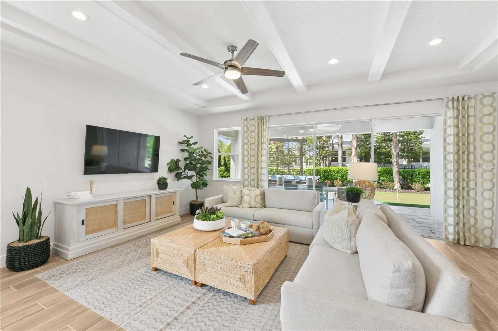 Large great room with stacking triple sliding doors to the expansive lanai for the perfect indoor/ outdoor living experience.