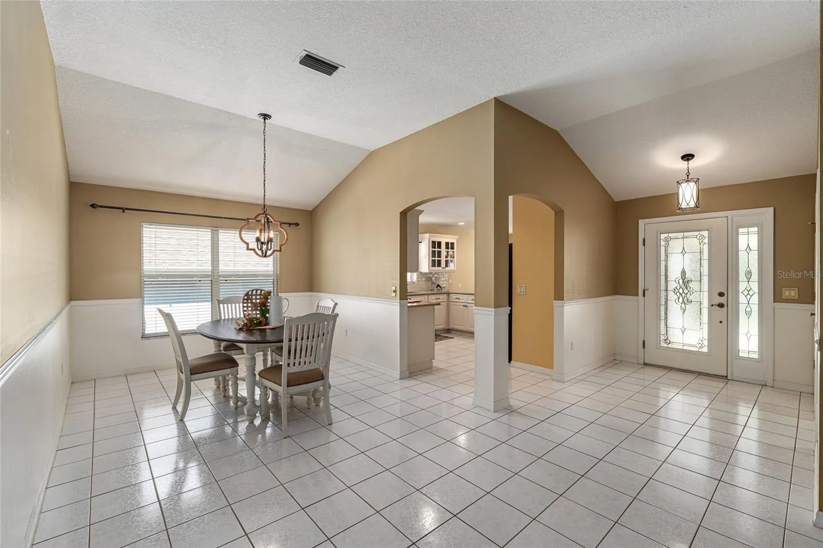 Dining Area: Dedicated dining space with tile flooring, chair rail detail, and a stylish light fixture for everyday meals or gatherings.