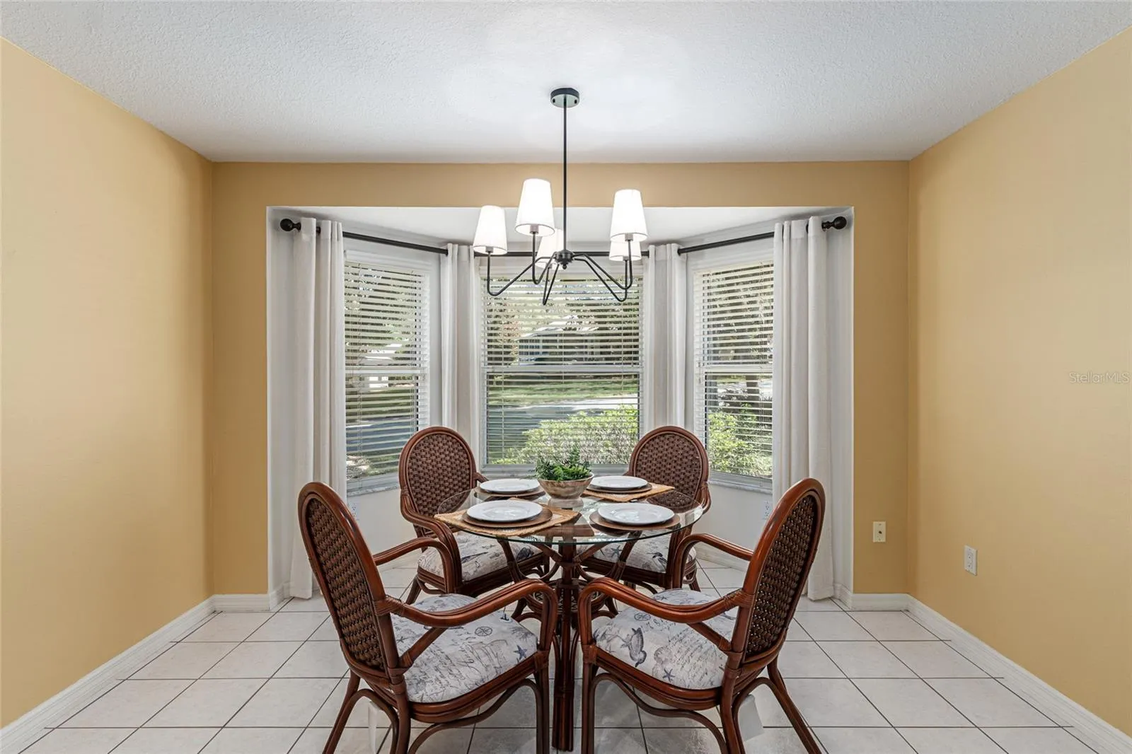 Breakfast Nook: Bright breakfast nook with bay-style windows and a modern light fixture creates an inviting space for casual dining.