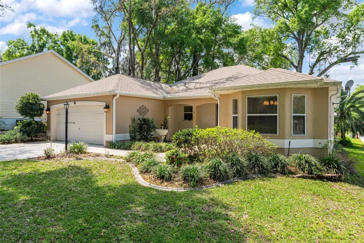 Front Exterior: Charming single-story home with a welcoming façade, mature trees, and well-maintained landscaping that enhances curb appeal.