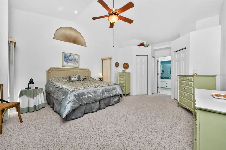 Spacious Primary Bedroom has a vaulted ceiling and ceiling fan.