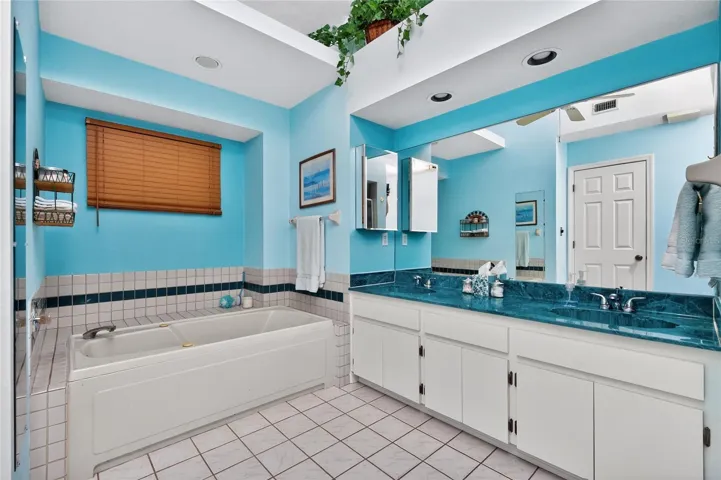 Primary bath has a double basin vanity w/cultured marble top
