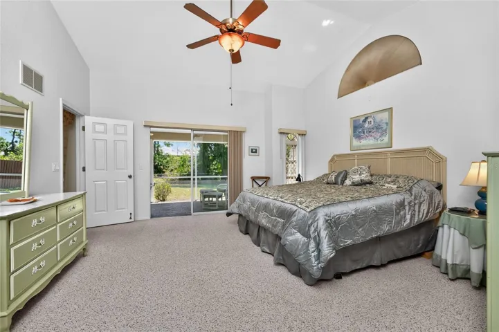 Primary bedroom has sliding glass doors opening onto the lanai