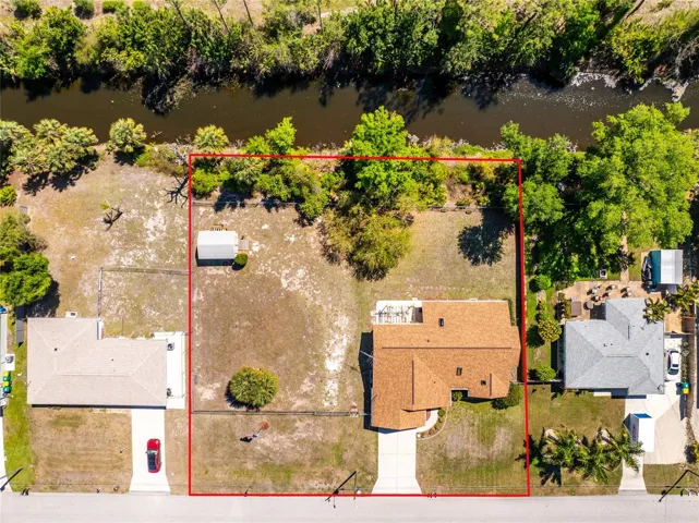Canal is behind the house and the extra lot is BUILDABLE!