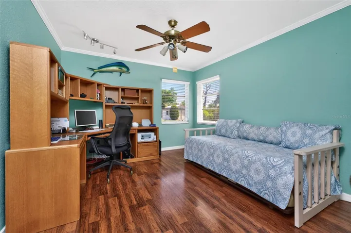 Bedroom #3 has laminate flooring and a ceiling fan.