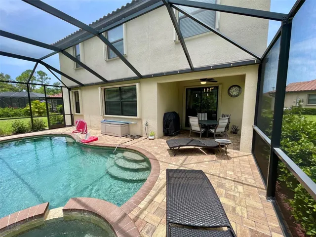Rear of Home From Spa Area SHowing Covered Outdoor Dining