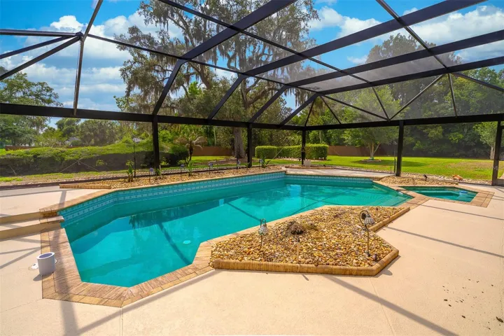 Pool Overlooks Lush Backyard