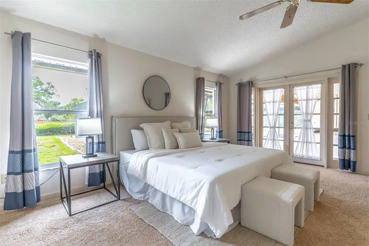 Large Primary Retreat with French Doors Providing Access to Patio and Pool