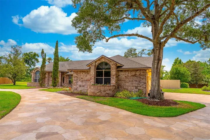 Front Exterior with Circular Drive and Side Drive Leading to 3-Car Garage