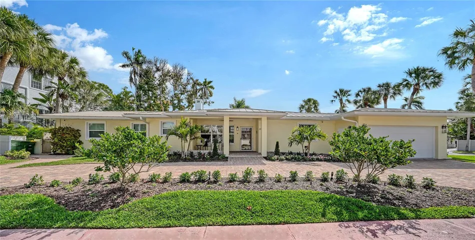 Featuring a two car garage and a circular brick paver driveway, this lovely home is 2 blocks from St Armand's Circle