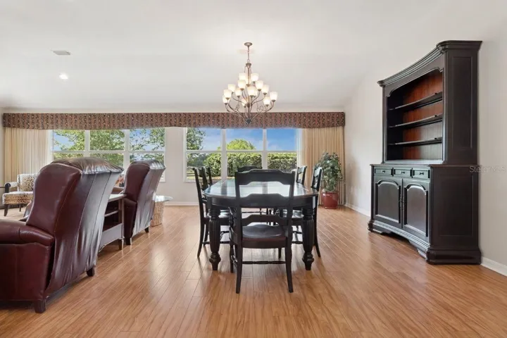 Dining room view with privacy hedge outside.