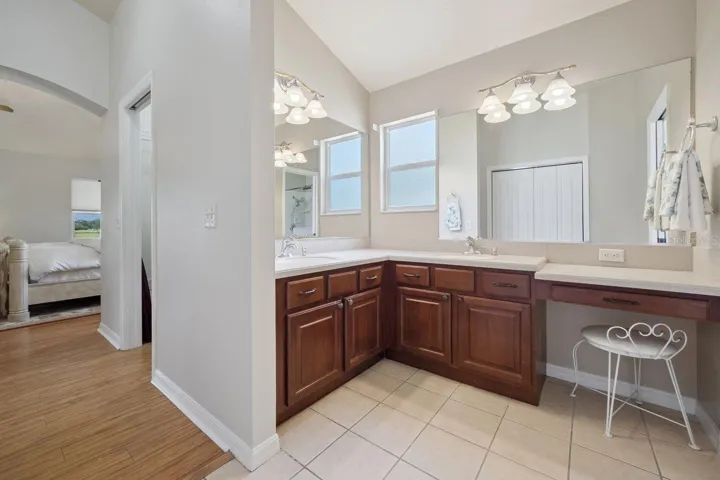 Master Bathroom sporting two sinks & sit under vanity.
