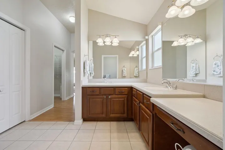 Master bathroom.Just after his & hers duel closets. Shows drop-down makeup area.