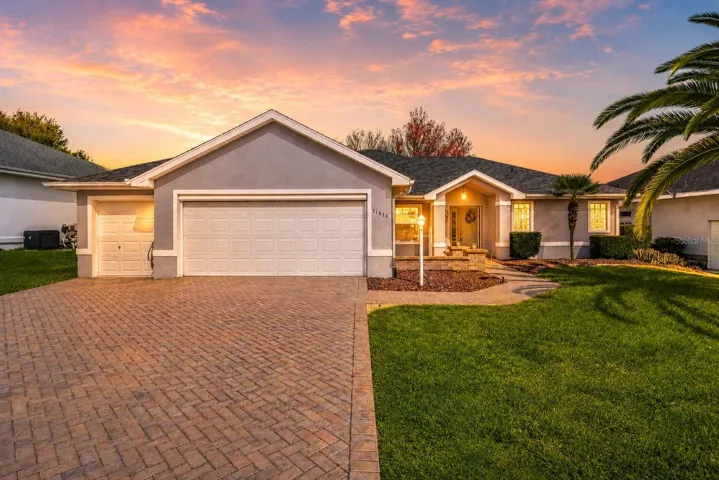 Exterior front home with no rear neighbors. Brick pavers welcome you into this 3/2 home with 2 car garage plus golf cart garage. BRAND NEW ROOF!