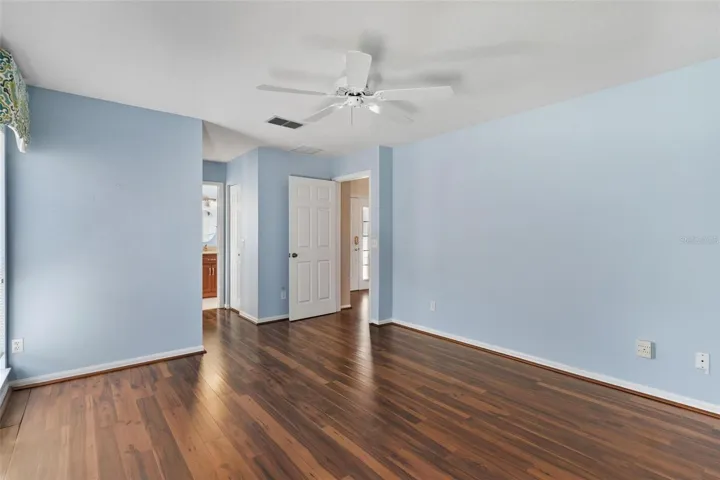 Primary suite features engineered wood flooring with sliders leadings to Family Room