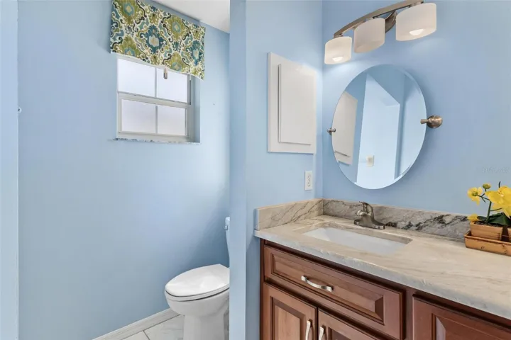 Primary bathroom features dual vanity sinks with tile shower/tub combo.