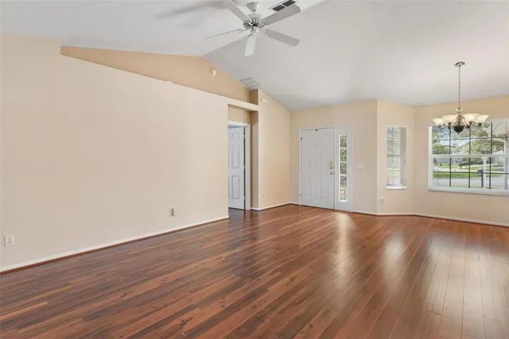 Interior entry greets you with high ceilings, engineered wood flooring overlooking the dining and Living Rooms