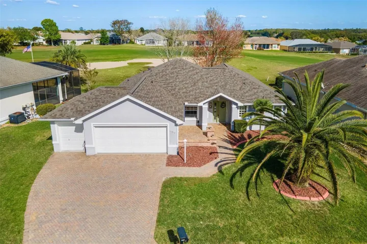 Exterior front home with no rear neighbors, 2 car garage + golf cart garage, and BRAND NEW ROOF!
