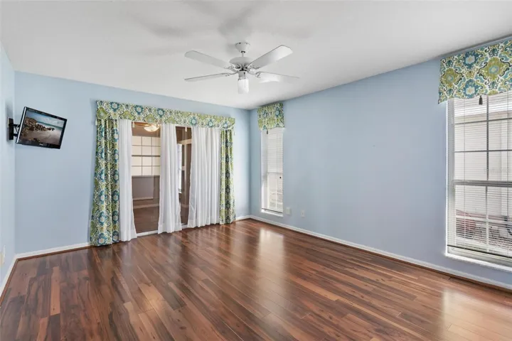 Primary suite features engineered wood flooring with sliders leadings to Family Room