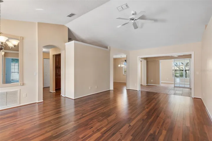 Interior entry greets you with high ceilings, engineered wood flooring overlooking the dining and living rooms