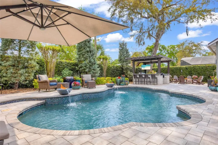 Panoramas view of pool that extends to the tailor-made summer kitchen