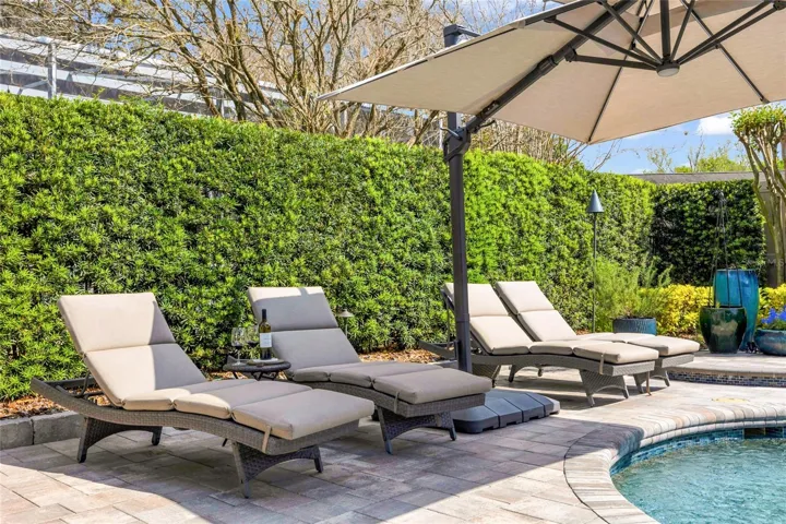 Pavered pool deck with space for lounging